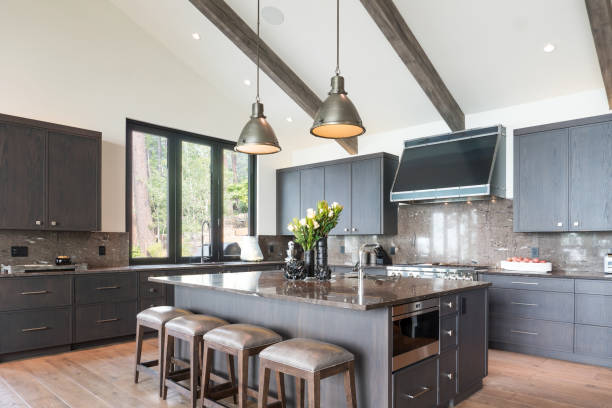 Vaulted ceiling in modern kitchen Kitchen island with four stools and two pendant lights above kitchen island stock pictures, royalty-free photos & images