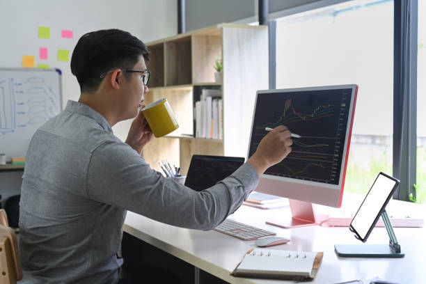 istock Side view businessman checking stock market on desktop computer at his office room. 1337185133