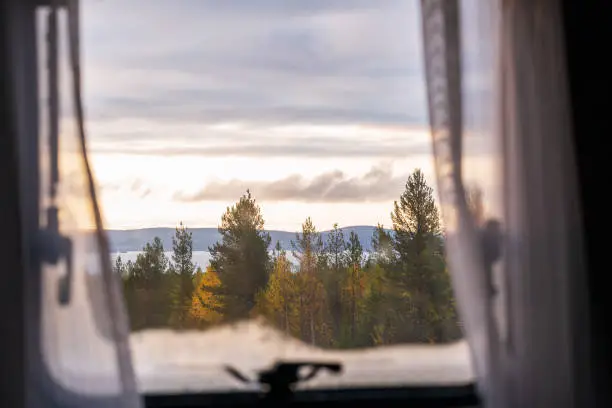 Photo of View from a window of camper to beautiful autumn landscape in Lapland, Finland