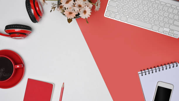istock Top view, coffee cup, headphone, smart phone and notebook on red and white background. 1337185469