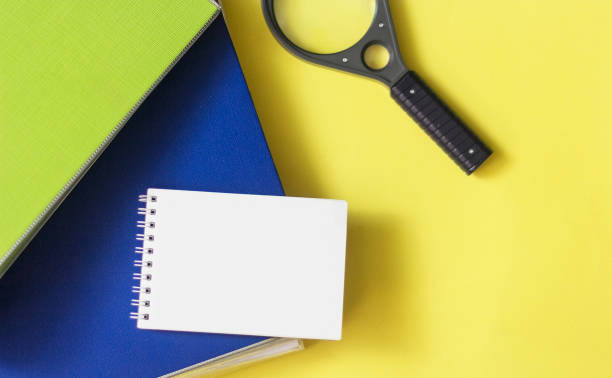 istock On a yellow background are folders for documents, a magnifying glass and a notebook for writing. Place to write 1337185758