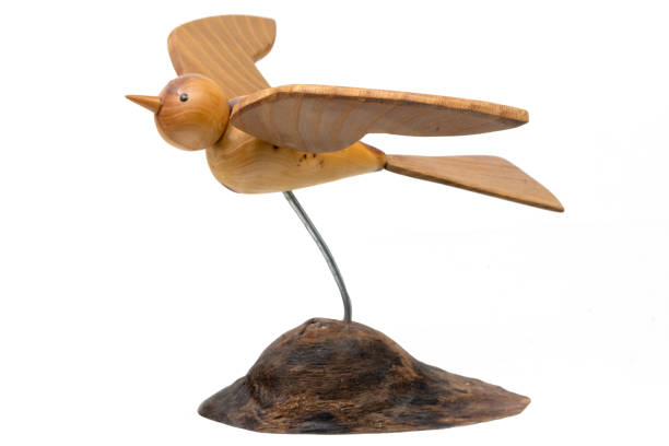 Wooden model of a turned flying bird isolated on white