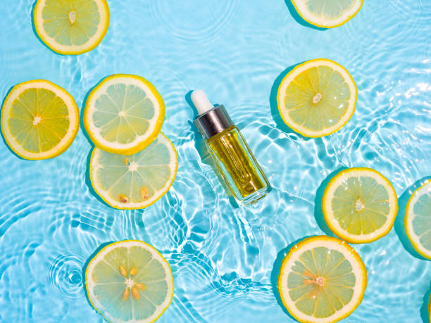 istock Cosmetic bottle in water, lemon slices, blue 1337186671