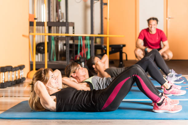 istock Side view of Athlete women doing abs exercise in gym 1337189355