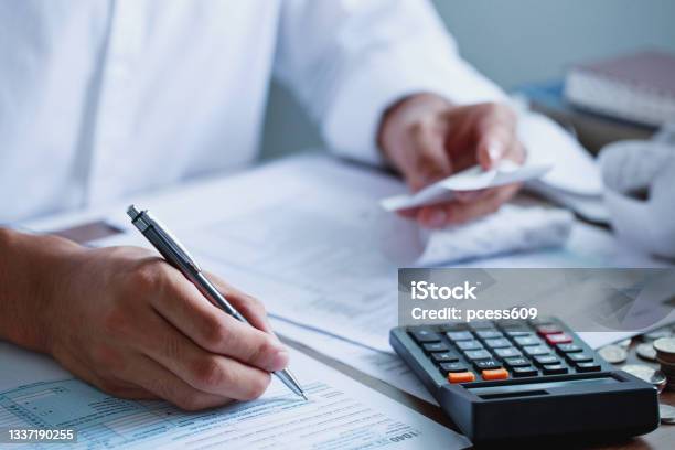 Man Hand Filling Us Tax Form Tax Form Us Business Income Office Financial Document Tax Timetax Concept Closeup Stock Photo - Download Image Now