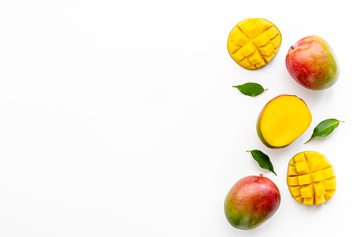 Layout of mango and leaves. Tropical fruits background.