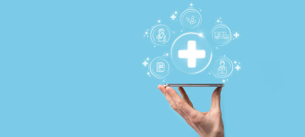 istock Businessman hold virtual plus medical network connection icons. Covid-19 pandemic develop people awareness and spread attention on their healthcare.Doctor,document,medicine,ambulance,patient icon. 1337193913