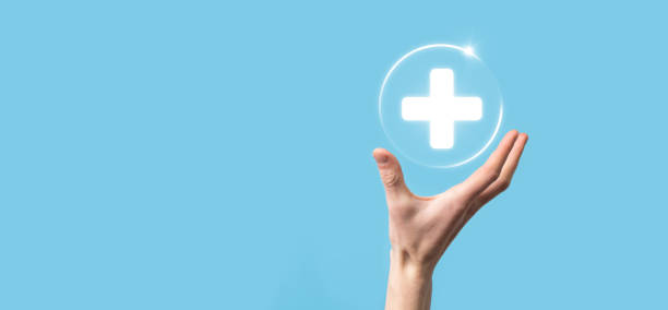 istock Businessman hold virtual plus medical network connection icons. Covid-19 pandemic develop people awareness and spread attention on their healthcare. 1337193915