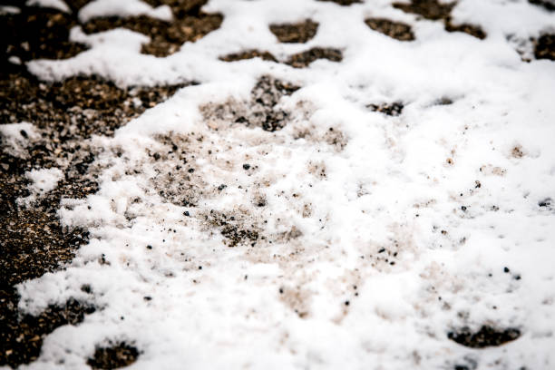 istock Thawing or road salt on snow and ice, concept black ice and defrosting or deicing 1337194144