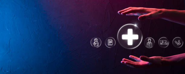 istock Businessman hold virtual plus medical network connection icons. Covid-19 pandemic develop people awareness and spread attention on their healthcare.Doctor,document,medicine,ambulance,patient icon. 1337194300