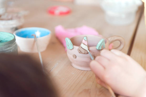istock girl modeling clay, hands close-up 1337195466