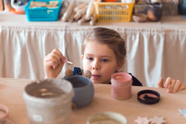 istock girl modeling clay 1337195482