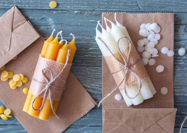 Handmade natural beeswax candles on a wooden background