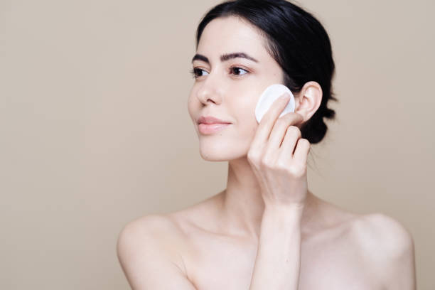 istock Young brunette woman removing makeup from her face 1337199248
