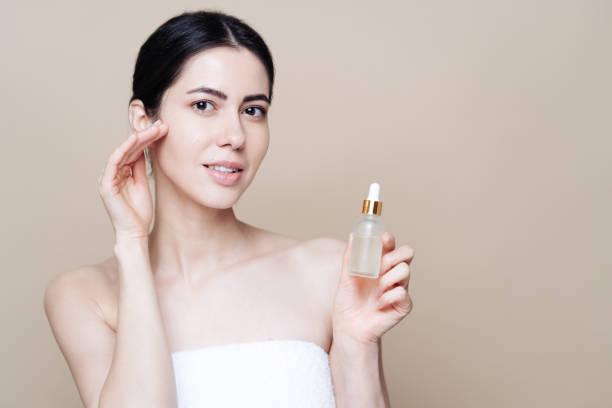 istock Caucasian woman holding bottle with serum 1337199631
