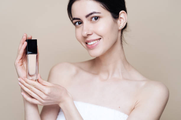 istock Caucasian woman holding bottle with Foundation 1337199716