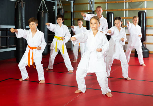 istock Karate kids in kimono performing kata moves 1337203008