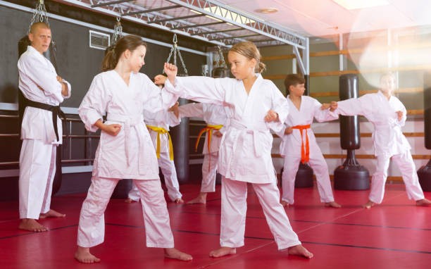 istock School girls practicing new karate moves in pairs 1337204022