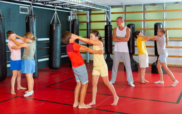 istock Kids in pair exercising self-defense movements 1337204291