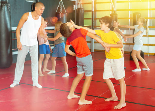 istock Kids in pairs training chin strike 1337204331