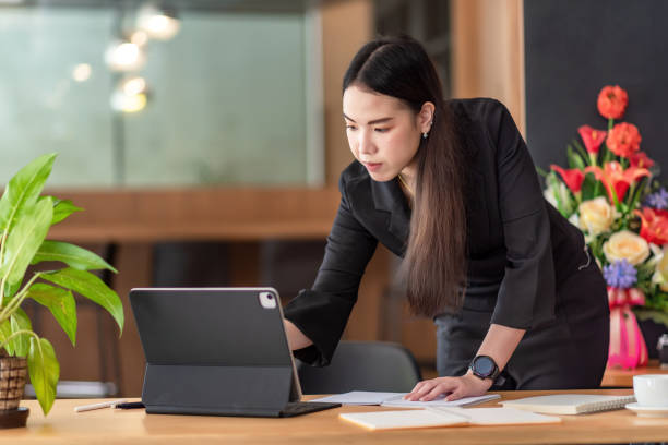 istock Asian businesswoman standing working using tablet and document place at the office. 1337204449
