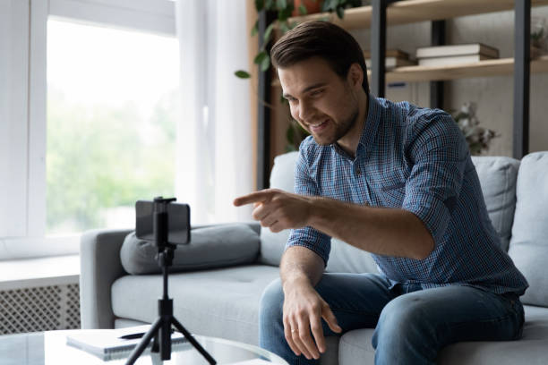 istock Happy positive vlogger shooting live content from home 1337206385