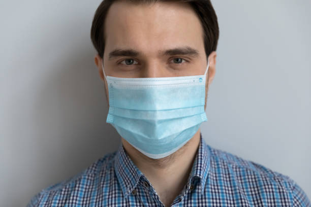 istock Handsome young man in medical protective mask on lower face 1337206388