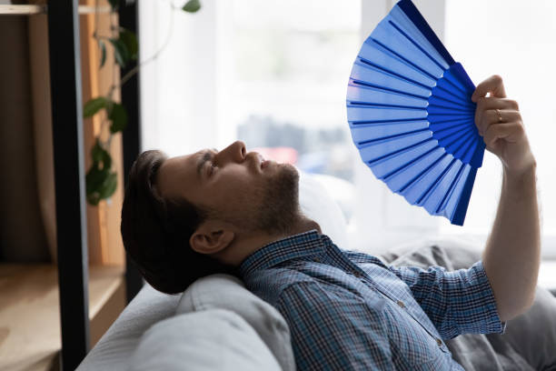 istock Exhausted overheated millennial man suffering from heat 1337206520
