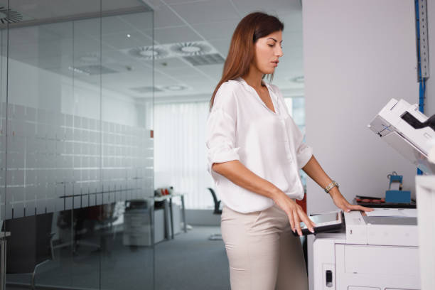 istock Female assistant programming xerox for number of copies in the office 1337206589