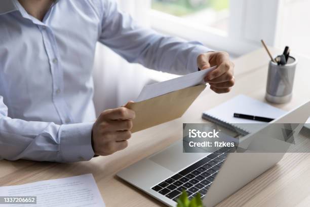 Hands Of Businessman Opening Envelope With White Paper Stock Photo - Download Image Now
