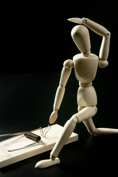 istock Wooden mannequin with mouse trap, black background 1337206962