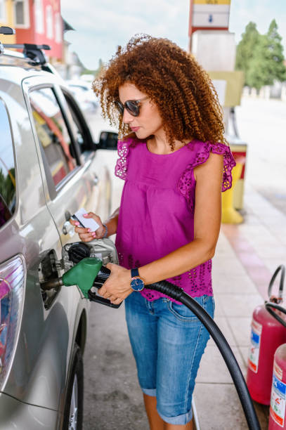 istock Young woman refuel the car 1337207255