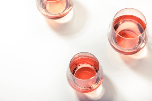 istock Rose wine glasses on white background. Wine tasting, top view, negative space 1337209503