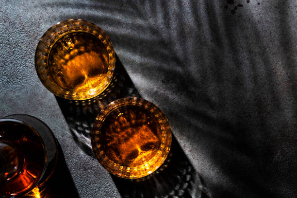 istock American bourbon whiskey in glasses and bottle, black background with shadow pattern and negative space 1337209525