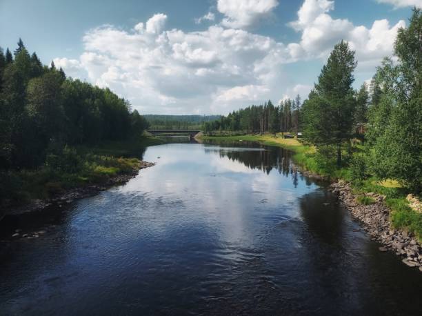 istock Cloudscape, river and forest in northern Sweden 1337210412