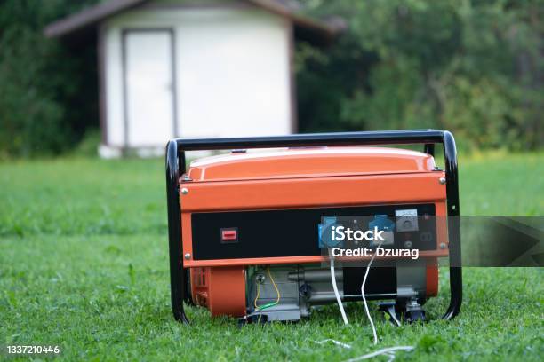 Portable Electric Generator On The Backyard Of A Summer House Outdoors Stock Photo - Download Image Now