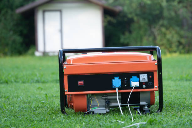 portable electric generator on the backyard of a summer house outdoors - gerador imagens e fotografias de stock