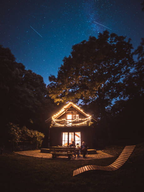 Cozy ecological forest house under the Milky May during Perseids