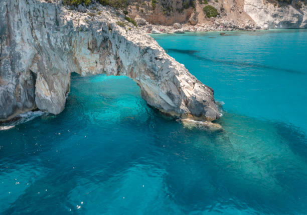Cala Goloritze with Natural Rock Arch, Gulf of Orosei, Sardinia, Italy - Aerial view stock photo