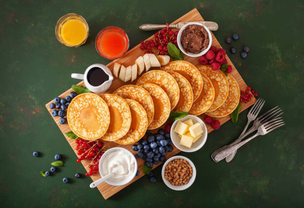 american pancake board with berries maple syrup butter - norway maple imagens e fotografias de stock