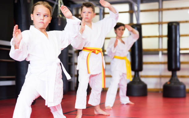 istock Karate kids in kimono performing kata moves 1337214539