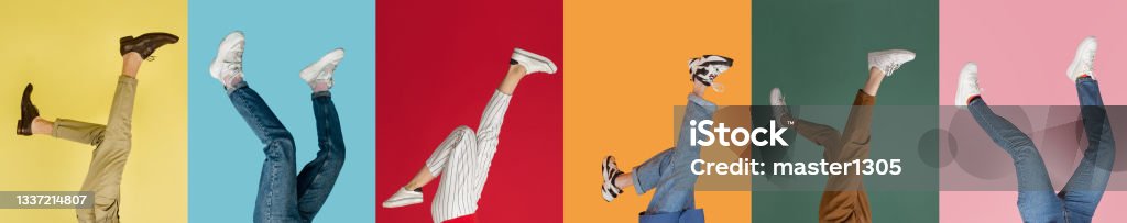 Collage with female and male legs in colored sneakers, trainers isolated over bright multicolored background. Heels over head, upside down. Collage with female and male legs in colored sneakers, trainers isolated over bright multicolored background. Concept of fashion, sales, discounts. Copyspase for ad. Shoe Stock Photo