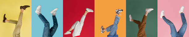 Collage with female and male legs in colored sneakers, trainers isolated over bright multicolored background. Heels over head, upside down. Collage with female and male legs in colored sneakers, trainers isolated over bright multicolored background. Concept of fashion, sales, discounts. Copyspase for ad. fashion photography color image colors stock pictures, royalty-free photos & images