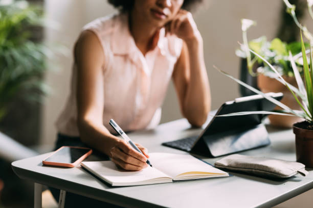 istock Anonymous Mixed Race Businesswoman Working in her Home Office 1337214919