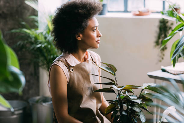 istock Beautiful Pensive Mixed Race Female Florist Sitting in her Workshop 1337214975