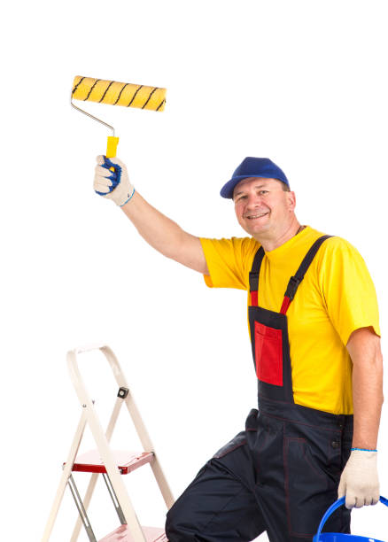 istock Smiling worker with paint roller and paint bucket. 1337216586