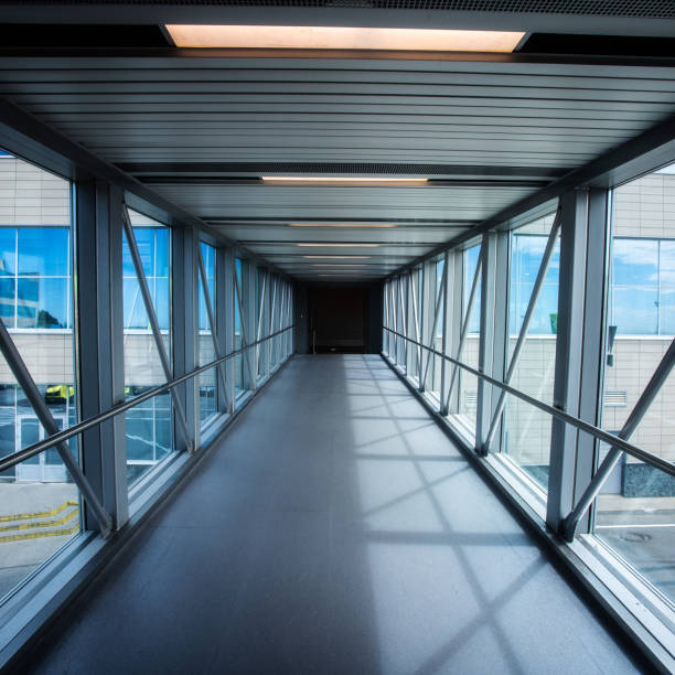 istock Empty transparent corridor for passengers to board the plane 1337217459