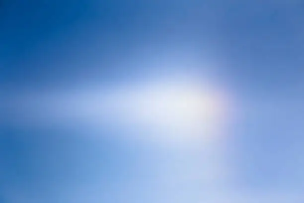Halo light effect in bright blue sky.
