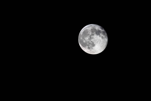 istock Waning gibbous, nearly full, moon on black background 1337217561