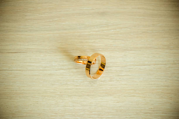 Wedding rings on a wooden table. the view from the top.